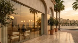 salons in jumeirah dubai: contemporary upscale beauty salon storefront along palm-lined Jumeirah Beach Road at golden hour