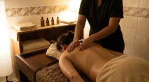 arabic massage dubai session: licensed therapist applying warm aromatic oil to a client back in a modest neighbourhood spa