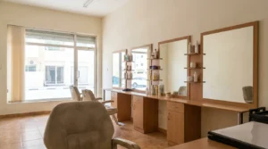 beauty salon international city: practical ladies salon interior with styling chairs and product shelves in a budget Warsan cluster