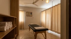 Massage in Dubai 50 AED: modest walk-in parlor treatment room with basic massage table rolled towels and ceiling fan in older Dubai district