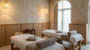 what is a couples massage: two prepared massage tables side by side in a warm neutral Dubai spa treatment room